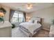 Bright bedroom featuring large windows, neutral tones, and a comfortable bed with decorative pillows at 1226 Clingman Dr, Fort Mill, SC 29715