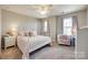Bedroom featuring stylish bed frame, desk and chair by large sunny windows, and plush bedding at 1226 Clingman Dr, Fort Mill, SC 29715
