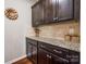 Butler pantry with granite countertops and dark wood cabinets at 1226 Clingman Dr, Fort Mill, SC 29715