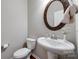 Elegant half bathroom featuring a pedestal sink, decorative mirror, and updated fixtures at 1226 Clingman Dr, Fort Mill, SC 29715