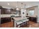 Spacious kitchen with a granite island, dark cabinets, and modern appliances at 1226 Clingman Dr, Fort Mill, SC 29715