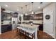 Modern kitchen featuring stainless steel appliances and a central granite island with seating at 1226 Clingman Dr, Fort Mill, SC 29715