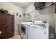 Functional laundry room includes a washer, dryer, storage cabinet, and shelving at 1226 Clingman Dr, Fort Mill, SC 29715