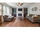 Cozy living room featuring a fireplace, hardwood floors, and built-in bookshelves at 1226 Clingman Dr, Fort Mill, SC 29715