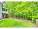 Lush green backyard featuring a playground and a picnic area, surrounded by mature trees and a well-maintained lawn at 14818 Hawick Manor Ln, Pineville, NC 28134