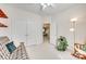 Bright bedroom with neutral carpet, light walls, double door closet and a view to another room at 14818 Hawick Manor Ln, Pineville, NC 28134