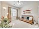 Calm bedroom featuring a ceiling fan, natural light and simple decor perfect for a bedroom or guest room at 14818 Hawick Manor Ln, Pineville, NC 28134