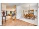 Formal dining room featuring hardwood floors, chandelier lighting, and a view into the living room at 14818 Hawick Manor Ln, Pineville, NC 28134