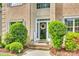Inviting front entrance with a wreath on the door, decorative plants, and cheerful welcome sign at 14818 Hawick Manor Ln, Pineville, NC 28134