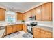 Well-lit kitchen with stainless steel appliances, granite countertops, and ample storage at 14818 Hawick Manor Ln, Pineville, NC 28134