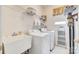 Efficient laundry room with washer, dryer, and storage shelves at 14818 Hawick Manor Ln, Pineville, NC 28134