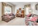 Cozy living room with sofas, piano, natural light, and classic decor at 14818 Hawick Manor Ln, Pineville, NC 28134