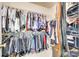 Organized walk-in closet with extensive shelving and hanging space for clothes and accessories at 14818 Hawick Manor Ln, Pineville, NC 28134
