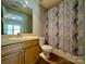 Cozy bathroom featuring a single sink vanity with storage and a shower tub with a modern shower curtain at 1745 Matheson Ave, Charlotte, NC 28205