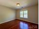 This cozy bedroom features natural light and hardwood flooring, creating a warm and inviting space at 1745 Matheson Ave, Charlotte, NC 28205
