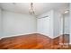 Spacious bedroom with hardwood floors, modern chandelier, and closet storage for comfortable living at 1745 Matheson Ave, Charlotte, NC 28205