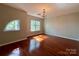 A well-lit bedroom features hardwood floors, modern lighting, and a sun-filled arched window at 1745 Matheson Ave, Charlotte, NC 28205