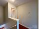 Upstairs hallway with access to multiple rooms, featuring hardwood flooring and neutral wall color at 1745 Matheson Ave, Charlotte, NC 28205