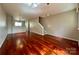 Open-concept living room featuring hardwood floors and stylish pendant lighting at 1745 Matheson Ave, Charlotte, NC 28205