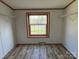 Simple bedroom with wood floors, closet shelving, and a window view at 196 Cindy Ln, Kings Mountain, NC 28086