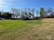 A charming single-story home with a wooden deck and surrounded by a lush green lawn and mature trees at 196 Cindy Ln, Kings Mountain, NC 28086