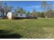 Exterior view showcasing home with a yard and wooden deck under blue sky at 196 Cindy Ln, Kings Mountain, NC 28086