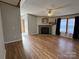 Bright living room with a stone fireplace, wood floors, and natural light streaming through the windows at 196 Cindy Ln, Kings Mountain, NC 28086