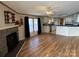 Open-concept living room with a stone fireplace, wood floors, and views of the kitchen at 196 Cindy Ln, Kings Mountain, NC 28086