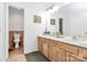 Well-lit bathroom with double vanity, tile flooring, and convenient access to the toilet area at 200 Port Royal Dr, Matthews, NC 28105
