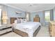 Comfortable bedroom with blue walls, plush bedding, and plenty of natural light at 200 Port Royal Dr, Matthews, NC 28105