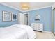 This charming bedroom features calming blue walls, white furniture and tasteful decor at 200 Port Royal Dr, Matthews, NC 28105