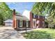 Charming brick two-story home with black shutters, manicured lawn and detached two-car garage at 200 Port Royal Dr, Matthews, NC 28105