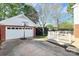 Two-car garage with a basketball hoop, and a view of the patio area in a backyard at 200 Port Royal Dr, Matthews, NC 28105