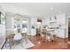Open concept kitchen with white cabinetry, hardwood floors, and eat-in dining area at 200 Port Royal Dr, Matthews, NC 28105