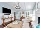 Airy living space featuring a fireplace, shiplap walls, modern lighting, and hardwood floors at 200 Port Royal Dr, Matthews, NC 28105