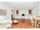 Open-concept room with built-in shelving, wainscoting, hardwood floors and a cozy seating area at 200 Port Royal Dr, Matthews, NC 28105