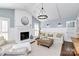 Bright living room with vaulted ceiling, fireplace, modern lighting, and stylish decor at 200 Port Royal Dr, Matthews, NC 28105