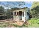Cozy porch house surrounded by lush greenery, with decorative flower boxes and a wooden walkway at 200 Port Royal Dr, Matthews, NC 28105