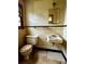 Dated bathroom featuring a toilet, sink, mirror and tile walls with black accents at 204 Long Creek Rd, Bessemer City, NC 28016