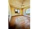 Shows a bedroom with hardwood flooring and an air conditioning unit in one of two windows at 204 Long Creek Rd, Bessemer City, NC 28016