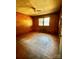 Bedroom with wood paneling, stained concrete floors and a window for natural light at 204 Long Creek Rd, Bessemer City, NC 28016
