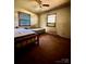 This bedroom has hardwood floors and two windows, one of which has an air conditioner at 204 Long Creek Rd, Bessemer City, NC 28016
