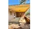 Exterior carport area with brick walls, a concrete floor and yellow ceiling at 204 Long Creek Rd, Bessemer City, NC 28016