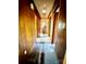 Hallway with wood paneling and visible stains on the flooring at 204 Long Creek Rd, Bessemer City, NC 28016