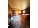 Living room with wood paneling, stained concrete floors and lots of potential at 204 Long Creek Rd, Bessemer City, NC 28016