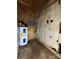 Small utility room with plywood and paneling, a water heater and electrical fixtures exposed at 204 Long Creek Rd, Bessemer City, NC 28016