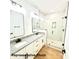 Bathroom featuring double vanities, granite countertops, and glass shower at 210 Carolina Dr # 1000&999, Troy, NC 27371