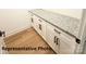 Granite countertops and white cabinets with sleek, black hardware make for ample storage at 210 Carolina Dr # 1000&999, Troy, NC 27371