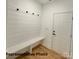 Mud room style entry with a white bench and wainscoting near the front door at 210 Carolina Dr # 1000&999, Troy, NC 27371