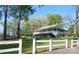 Beautiful property with white fence and lush greenery at 210 Carolina Dr # 1000&999, Troy, NC 27371